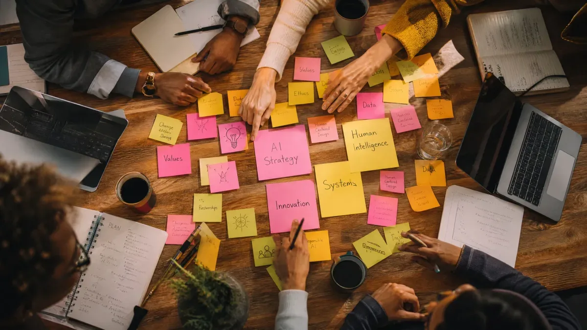 Workshop brainstorming table with AI strategy sticky notes